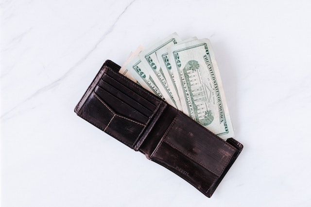 a wallet with twenty dollar bills in it